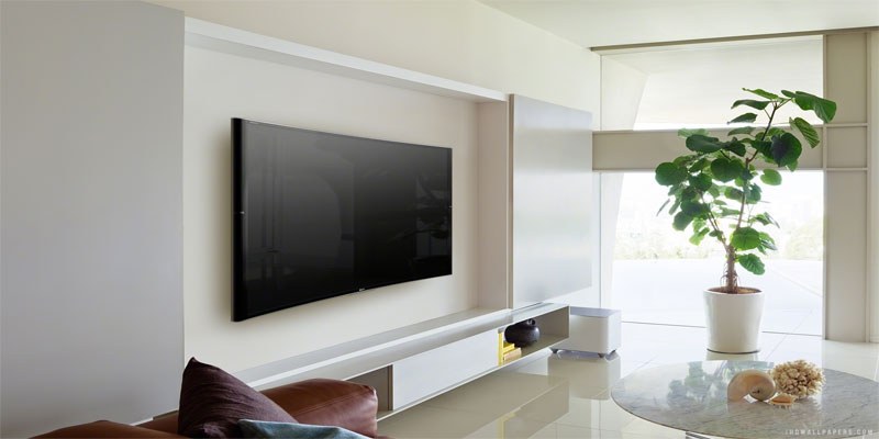 Handyman attaching a TV to a wall mount