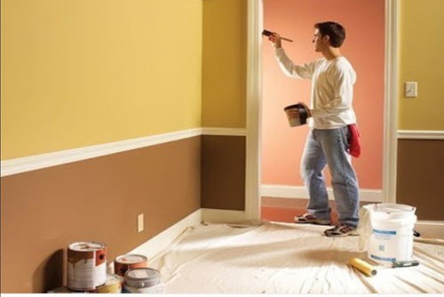Painter rolling a fresh coat on an interior wall