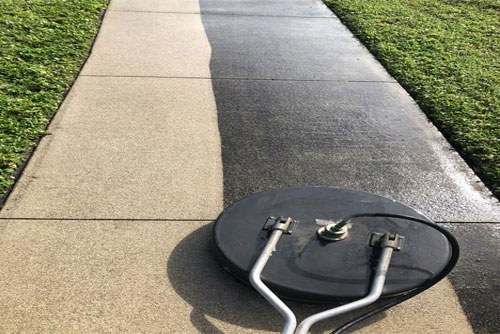 Pressure washing a driveway clean